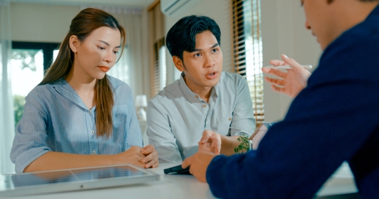 couple in serious discussion with a professional
