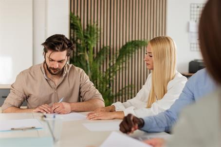 couple signing documents in lawyer's office
